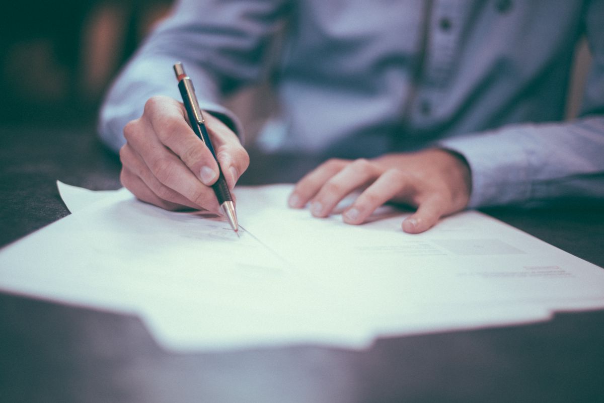 A photo by photographer Scott Graham of a person's hands writing on a piece of paper
